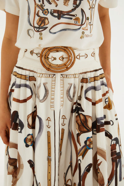 Winter white midi skirt with equestrian print, A-line cut, and a removable belt, styled elegantly with a casual top.