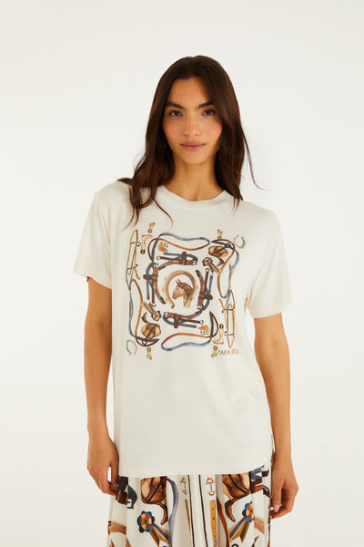 Off-white slim fit t-shirt with equestrian-inspired terracotta, navy, and gold print. Features short sleeves and round neckline.