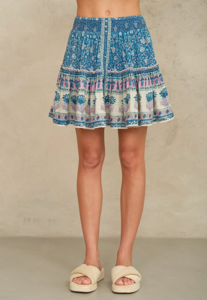 Myla Print Mini Skirt in teal floral cotton with tiered silhouette, elastic waist, lace trim, and front button detail