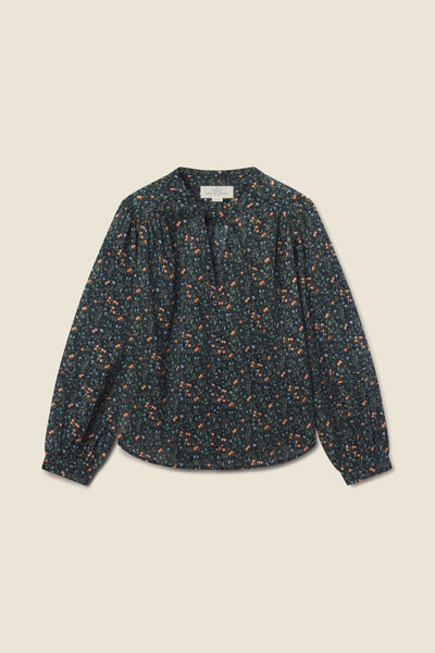 Pauline Blouse in navy cotton featuring a delicate floral pattern, v-neckline, and romantic shirred cuffs.