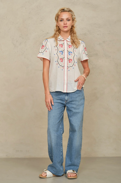 Ruby Embroidered Top in ecru textured cotton with floral cross stitch, Peter Pan collar, short sleeves, and button front