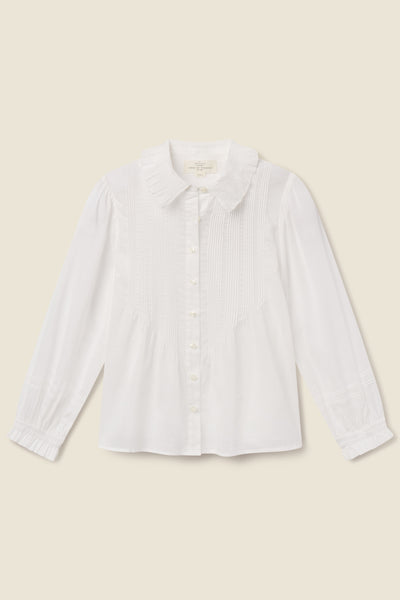 Fitted white cotton voile blouse with oversized point collar, pintucked front, and ruffled cuffs.